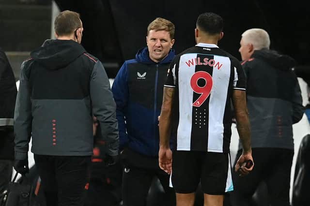 Head coach Eddie Howe speaks with Newcastle United's Callum Wilson as he leaves the game injured.