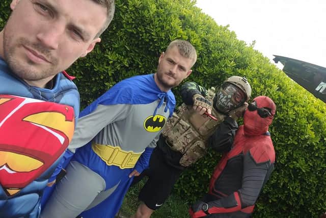 The four lads dressed as superheroes on the final day of the challenge
