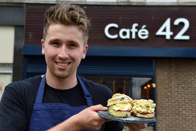 Cafe 42 owner Sam Clark with his cream scones.