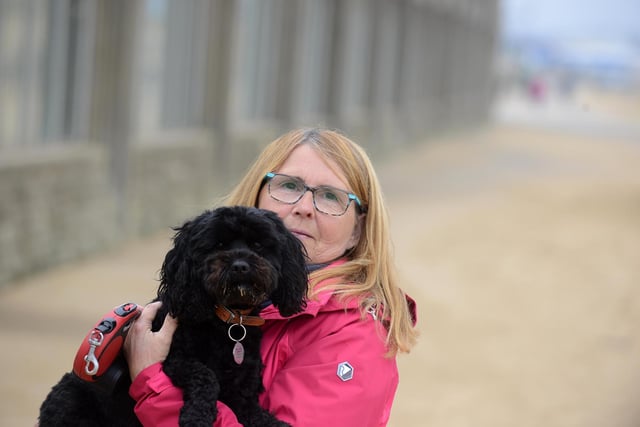 Despite the cooler conditions Shiela Walton still made it out to the beach with dog Buddy.