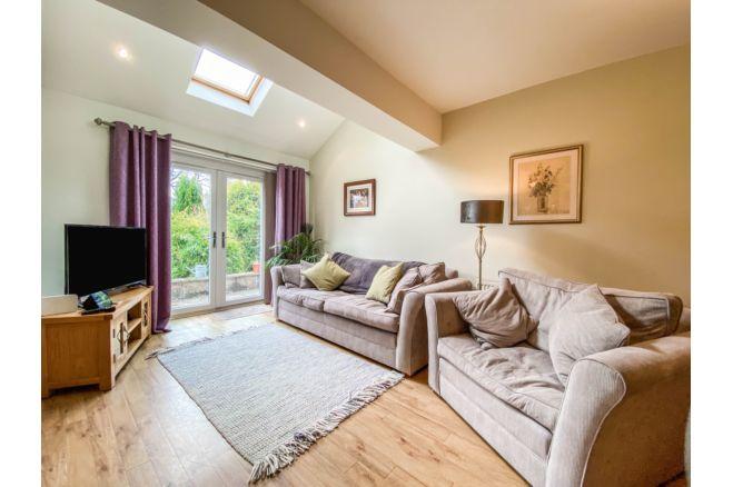 The spacious layout offers a chance to relax and access to the garden via patio doors.