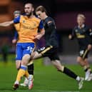 John-Joe O'Toole (L) of Mansfield Town is tackled by Lucas De Bolle of Newcastle United during the Papa John's EFL Trophy Group match between Mansfield  Town and Newcastle United U21 at  on November 09, 2021 in Mansfield, England. (Photo by Laurence Griffiths/Getty Images)