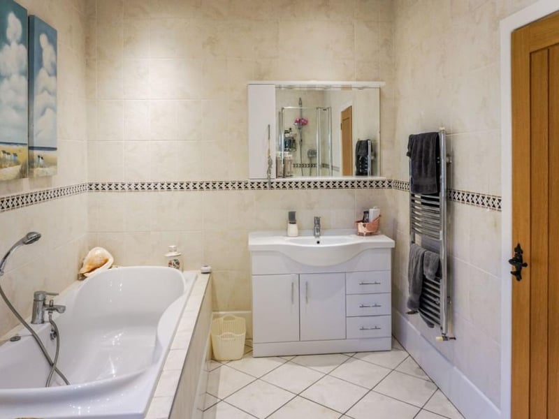 Family bathroom benefits from underfloor heating and is fitted with a four piece suite.