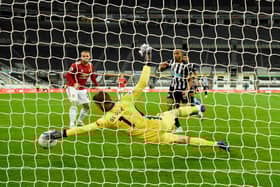 Manchester United goalkeeper David de Gea makes a superb save from a shot from Callum Wilson (r) during the Premier League match between Newcastle United and Manchester United at St. James Park on October 17, 2020 in Newcastle upon Tyne, England.
