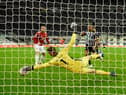 Manchester United goalkeeper David de Gea makes a superb save from a shot from Callum Wilson (r) during the Premier League match between Newcastle United and Manchester United at St. James Park on October 17, 2020 in Newcastle upon Tyne, England.