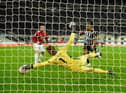 Manchester United goalkeeper David de Gea makes a superb save from a shot from Callum Wilson (r) during the Premier League match between Newcastle United and Manchester United at St. James Park on October 17, 2020 in Newcastle upon Tyne, England.