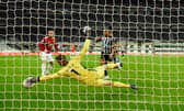 Manchester United goalkeeper David de Gea makes a superb save from a shot from Callum Wilson (r) during the Premier League match between Newcastle United and Manchester United at St. James Park on October 17, 2020 in Newcastle upon Tyne, England.