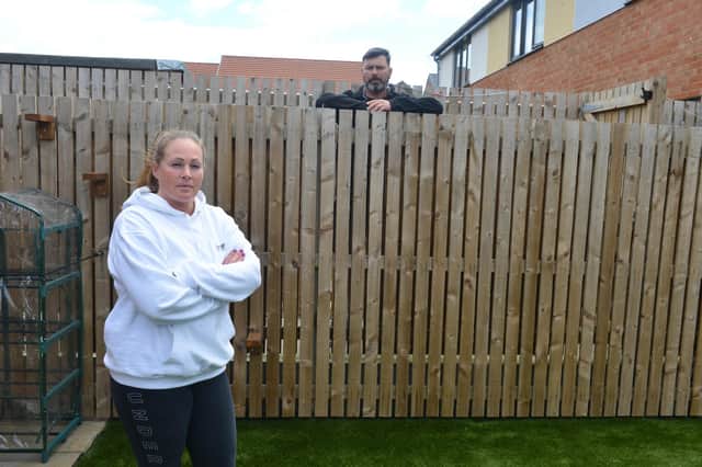 Garden Gate Drive residents Lee and Mel Taylor are unhappy with different fence heights with neighbours
