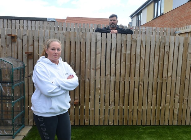 Garden Gate Drive residents Lee and Mel Taylor are unhappy with different fence heights with neighbours