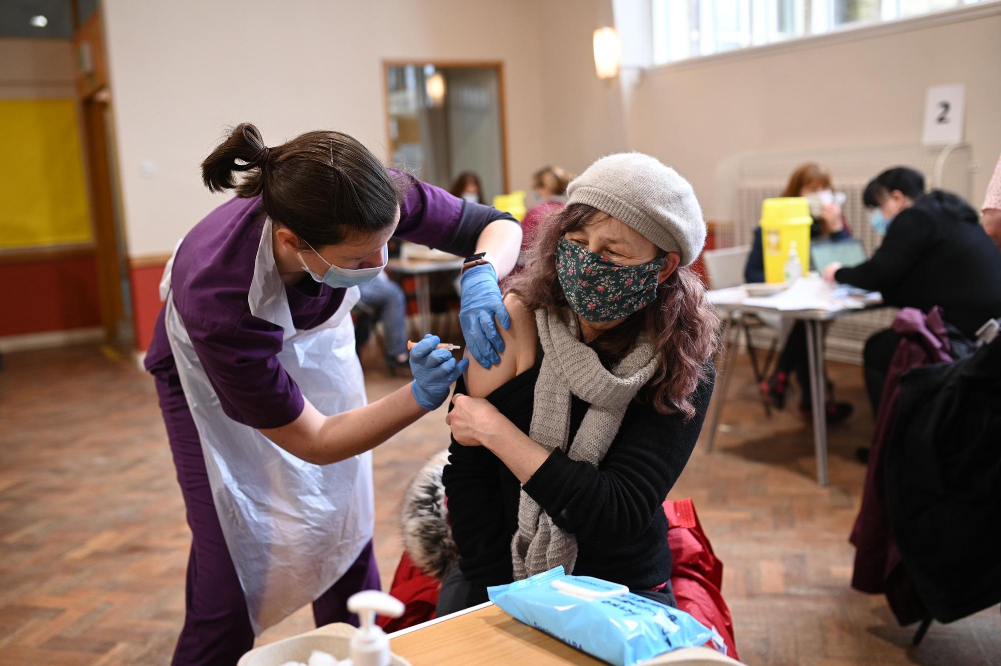 Doctor Kate Martin (L) administers an injection of AstraZeneca/Oxford Covid-19 vaccine to a patient (Photo by Oli SCARFF / AFP) (Photo by OLI SCARFF/AFP via Getty Images)