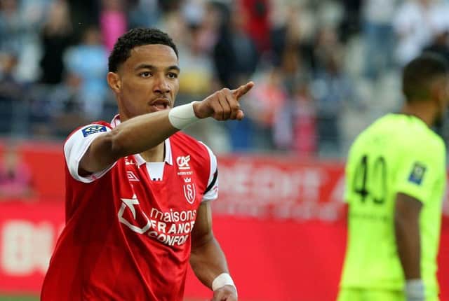 Reims' French forward Hugo Ekitike celebrates after scoring a goal during (Photo by FRANCOIS NASCIMBENI / AFP)