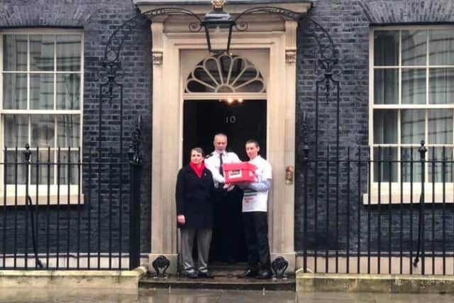 Christopher Head and Kate Osborne hand over the petition to Downing Street.