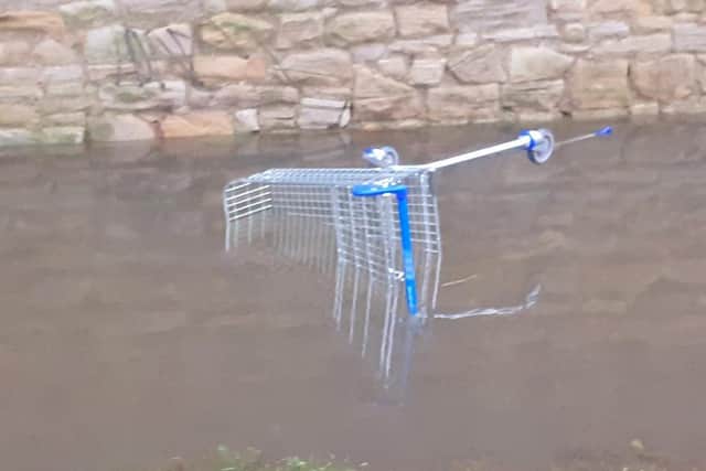 This abandoned shopping trolley was among the debris in the floodwater.