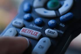 In this illustration photo taken on July 19, 2022 the Netflix logo is seen on a TV remote in Los Angeles. - Netflix reported losing subscribers for the second quarter in a row Tuesday as the streaming giant battles fierce competition and viewer belt tightening, but the company assured investors of better days ahead. The loss of 970,000 paying customers in the most recent quarter was not as big as expected, and left Netflix with just shy of 221 million subscribers. (Photo by Chris DELMAS / AFP) (Photo by CHRIS DELMAS/AFP via Getty Images)