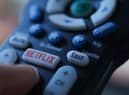 In this illustration photo taken on July 19, 2022 the Netflix logo is seen on a TV remote in Los Angeles. - Netflix reported losing subscribers for the second quarter in a row Tuesday as the streaming giant battles fierce competition and viewer belt tightening, but the company assured investors of better days ahead. The loss of 970,000 paying customers in the most recent quarter was not as big as expected, and left Netflix with just shy of 221 million subscribers. (Photo by Chris DELMAS / AFP) (Photo by CHRIS DELMAS/AFP via Getty Images)