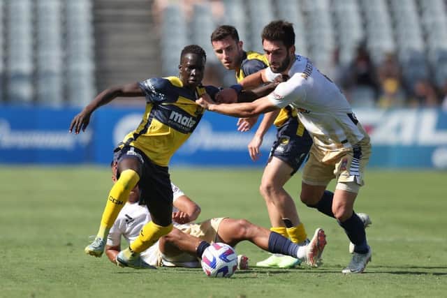 Garang Kuol of the Mariners competes for the ball with with Beka Mikeltadze of the Jets during the round  7 A-League Men's match between Central Coast Mariners and Newcastle Jets at Central Coast Stadium, on December 11, 2022, in Gosford, Australia. (Photo by Scott Gardiner/Getty Images)