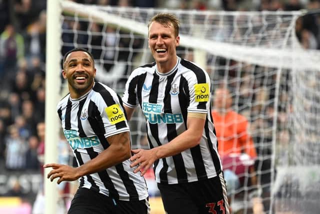 Newcastle striker Callum Wilson celebrates with Dan Burn (r) after scoring his second goal during the Premier League match between Newcastle United and Aston Villa at St. James Park on October 29, 2022 in Newcastle upon Tyne, England. (Photo by Stu Forster/Getty Images)