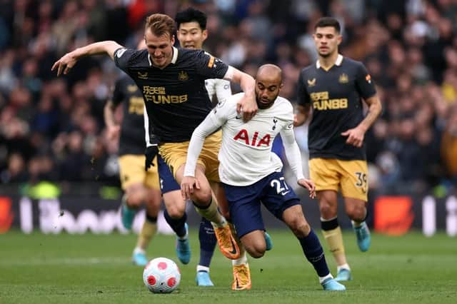 Lucas Moura of Tottenham Hotspur is challenged by Dan Burn of Newcastle United during the Premier League match between Tottenham Hotspur and Newcastle United at Tottenham Hotspur Stadium on April 03, 2022 in London, England. (Photo by Ryan Pierse/Getty Images)