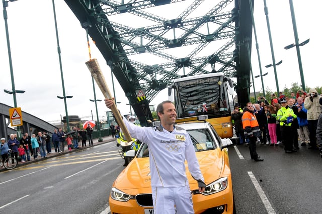 Micah Berger with the torch on Wearmouth Bridge.