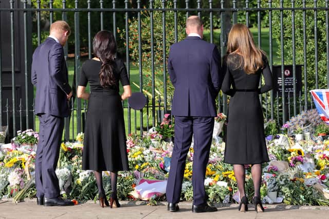 Prince Harry, Duke of Sussex, Meghan, Duchess of Sussex, Prince William, Prince of Wales, and Catherine, Princess of Wales, look at floral tributes laid by members of the public at Windsor Castle on September 10. Picture: Chris Jackson/Getty Images.