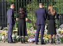 Prince Harry, Duke of Sussex, Meghan, Duchess of Sussex, Prince William, Prince of Wales, and Catherine, Princess of Wales, look at floral tributes laid by members of the public at Windsor Castle on September 10. Picture: Chris Jackson/Getty Images.
