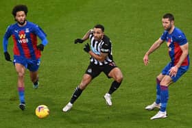 NEWCASTLE UPON TYNE, ENGLAND - FEBRUARY 02: Crystal Palace defender Gary Cahill (r) and Jairo Riedewald challenge Callum Wilson of Newcastle during the Premier League match between Newcastle United and Crystal Palace at St. James Park on February 02, 2021 in Newcastle upon Tyne, England.