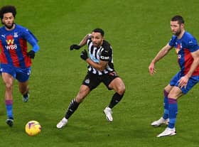 NEWCASTLE UPON TYNE, ENGLAND - FEBRUARY 02: Crystal Palace defender Gary Cahill (r) and Jairo Riedewald challenge Callum Wilson of Newcastle during the Premier League match between Newcastle United and Crystal Palace at St. James Park on February 02, 2021 in Newcastle upon Tyne, England.