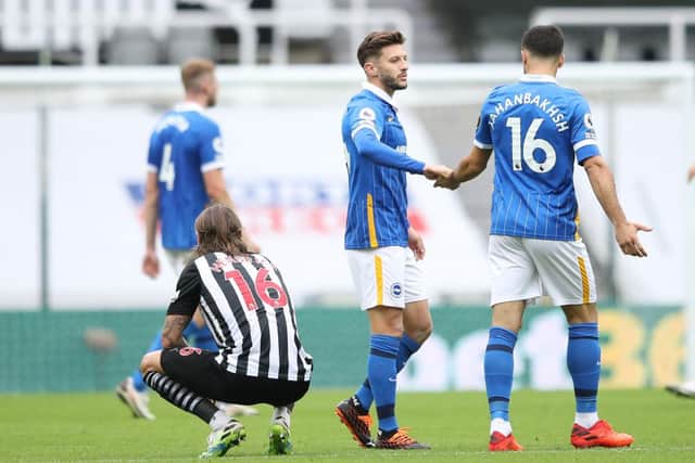 Brighton's English midfielder Adam Lallana (C) and Brighton's Iranian midfielder Alireza Jahanbakhsh (R) react after winning the English Premier League football match between Newcastle United and Brighton and Hove Albion at St James' Park in Newcastle upon Tyne, north-east England on September 20, 2020.