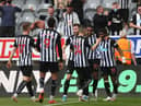 Joe Willock of Newcastle United celebrates with team mates Miguel Almiron and Allan Saint-Maximin after scoring his team's first goal during the Premier League match between Newcastle United and Sheffield United at St. James Park on May 19, 2021 in Newcastle upon Tyne, England.