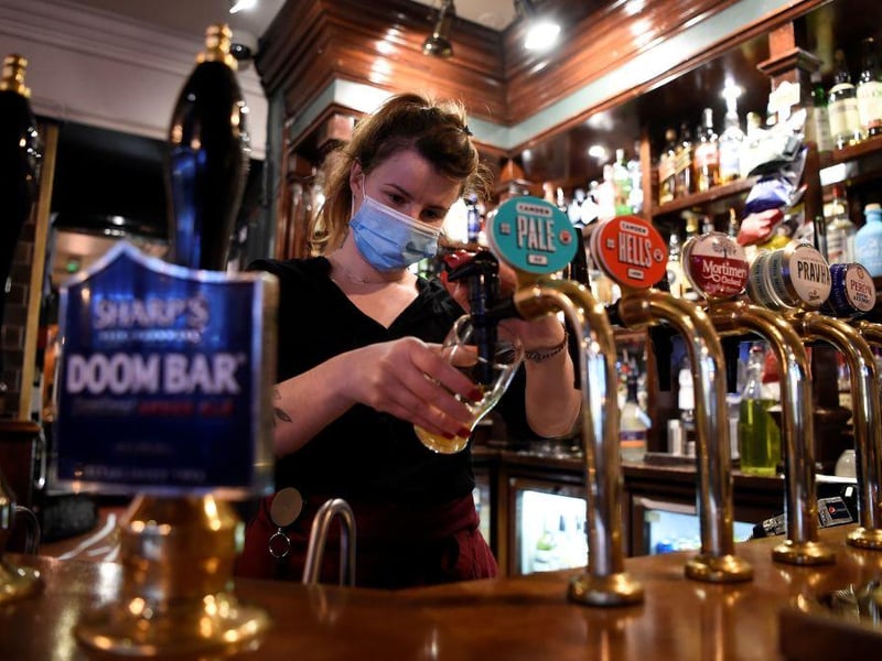 Restaurants, pubs, bars and cafes can open indoors until 10.30pm serving alcohol with two hour pre-booked slots. (Picture: AFP via Getty Images)