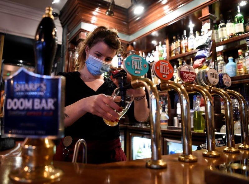 Restaurants, pubs, bars and cafes can open indoors until 10.30pm serving alcohol with two hour pre-booked slots. (Picture: AFP via Getty Images)