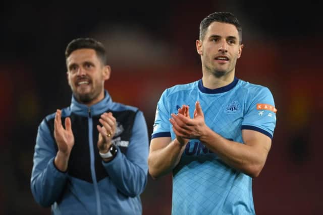 Fabian Schar of Newcastle United (R) and assistant head coach Jason Tindall applaud the travelling fans at the end of the Premier League match between Southampton and Newcastle United at St Mary's Stadium on March 10, 2022 in Southampton, England.  (Photo by Mike Hewitt/Getty Images)