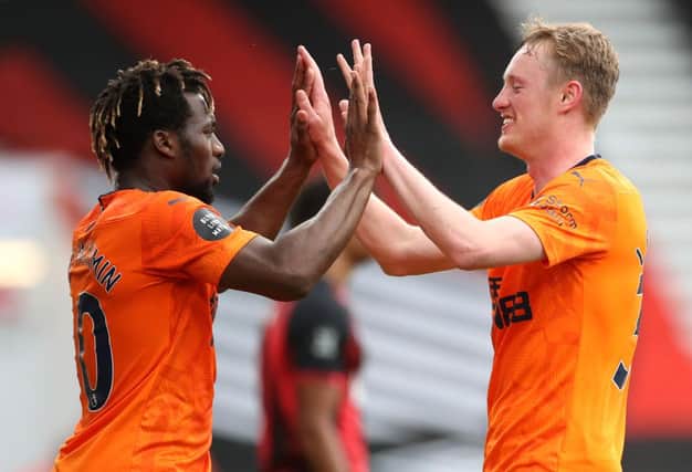 BOURNEMOUTH, ENGLAND - JULY 01: Sean Longstaff of Newcastle United celebrates after scoring his team's second goal with team mate Allan Saint-Maximin during the Premier League match between AFC Bournemouth and Newcastle United at Vitality Stadium on July 01, 2020 in Bournemouth, England.