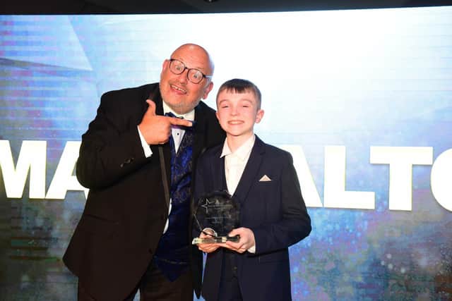 Young Performer of the Year Award winner Max Walton receives his award from Ray Spencer .