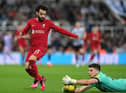Nick Pope handles the ball outside his box against Liverpool.