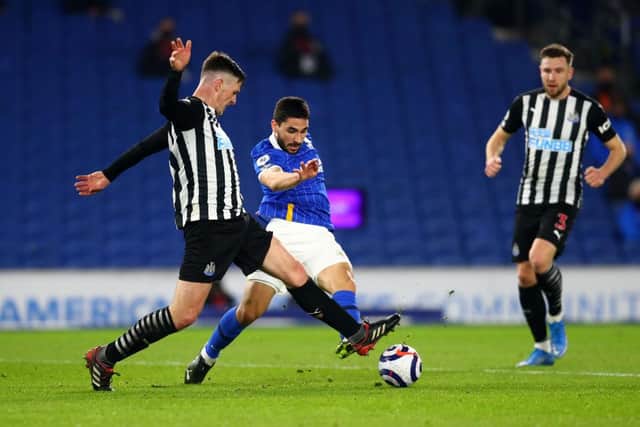 Neal Maupay of Brighton & Hove Albion is challenged by Ciaran Clark of Newcastle United during the Premier League match between Brighton & Hove Albion and Newcastle.
