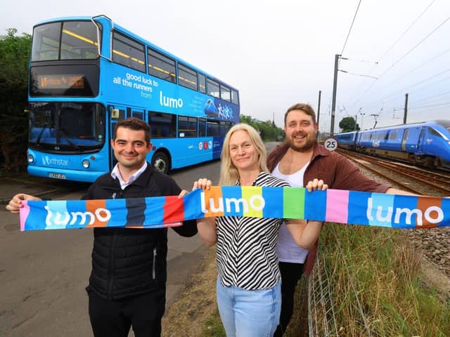 Bus driver Dan Graham with charity singers Susan Bicke and Stuart Angus