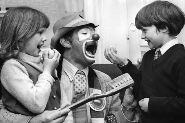 Pierre the clown shows Joanne Grainger and Michael Reeder that eating apples is not only fun but also good for cleaning teeth. Remember this from 1971? Apple Day is here on October 21.