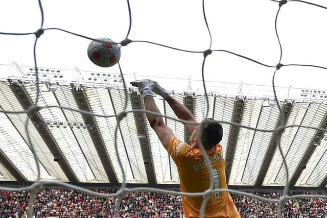 Newcastle United's Slovakian goalkeeper Martin Dubravka stops the during the English Premier League football match between Newcastle United and Liverpool at St James' Park in Newcastle-upon-Tyne, north east England on April 30, 2022. (Photo by PAUL ELLIS/AFP via Getty Images)