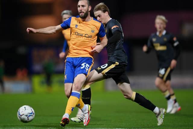 John-Joe O'Toole (L) of Mansfield Town is tackled by Lucas De Bolle of Newcastle United during the Papa John's EFL Trophy Group match between Mansfield Town and Newcastle United U21 at on November 09, 2021 in Mansfield, England. (Photo by Laurence Griffiths/Getty Images)