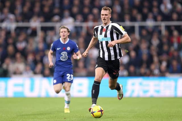 Dan Burn of Newcastle United runs with the ball during the Premier League match between Newcastle United and Chelsea FC at St. James Park on November 12, 2022 in Newcastle upon Tyne, England. (Photo by George Wood/Getty Images)