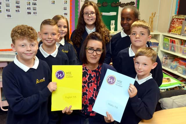 Ashley Academy pupils working on their English and Maths with headteacher Denise Todd.