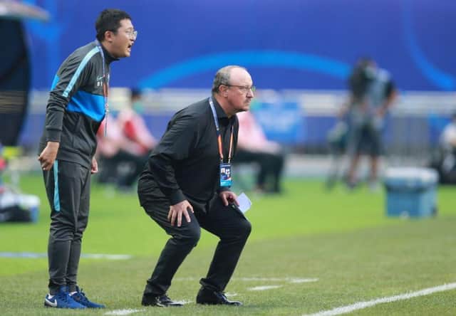 Dalian Pro coach Rafael Benitez (R) watches his players during their their Chinese Super League match against Shanghai Shenhua in Dalian, in China's northeast Liaoning province on August 10, 2020. (Photo by STR / AFP) / China OUT (Photo by STR/AFP via Getty Images)