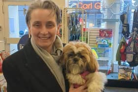 MP Kate Osborne giving a pet dog what they love, a good hug.