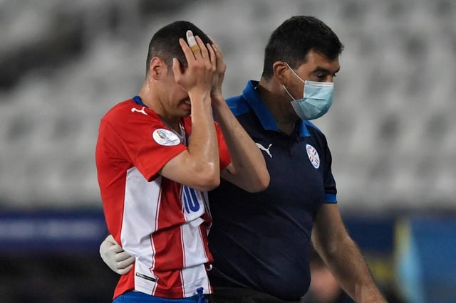 Miguel Almiron leaves the field after suffering an injury against Uruguay.