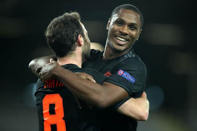 Juan Mata of Manchester United celebrates with Odion Ighalo.