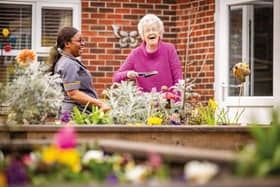 Resident and care home colleague in outdoor area of HC-One care home