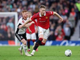Scott McTominay of Manchester United battles for possession with Harrison Reed of Fulham during the Emirates FA Cup Quarter Final match between Manchester United and Fulham at Old Trafford on March 19, 2023 in Manchester, England. (Photo by Clive Brunskill/Getty Images)