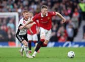 Scott McTominay of Manchester United battles for possession with Harrison Reed of Fulham during the Emirates FA Cup Quarter Final match between Manchester United and Fulham at Old Trafford on March 19, 2023 in Manchester, England. (Photo by Clive Brunskill/Getty Images)