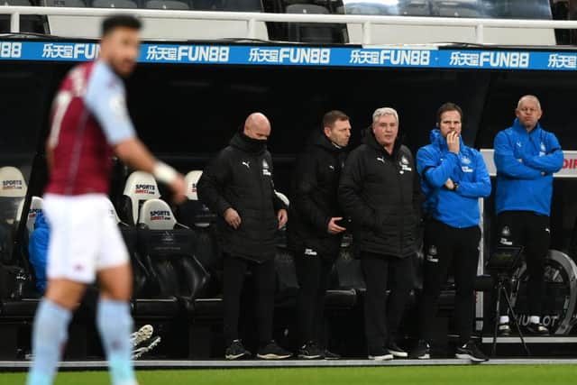 Newcastle manager Steve Bruce (c) and his coaches react during the Premier League match between Newcastle United and Aston Villa at St. James Park on March 12, 2021 in Newcastle upon Tyne, England.
